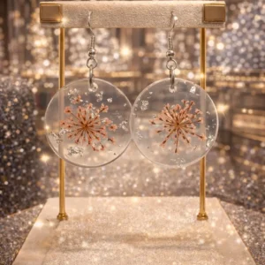hand made transparent resin art earrings with pink flower and snowflake design